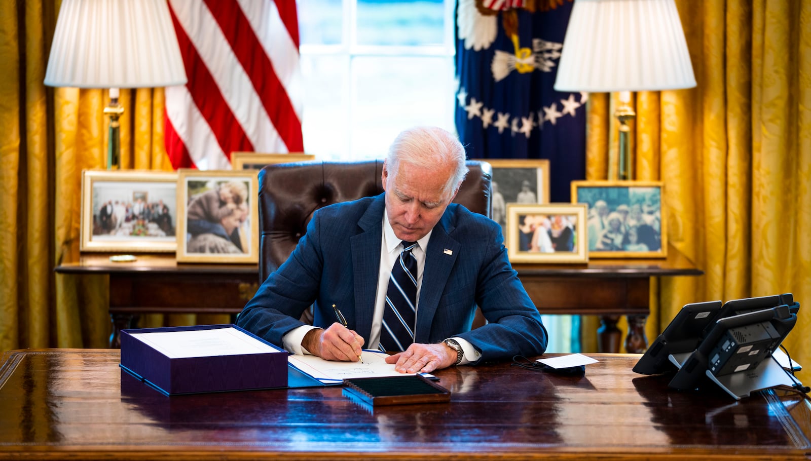 President Joe Biden signs into law the $1.9 trillion economic relief plan at the White House in Washington, Thursday, March 11, 2021. The economic relief package includes a last-minute change that seeks to temporarily prevent states that receive government aid from turning around and cutting taxes. (Doug Mills/The New York Times)