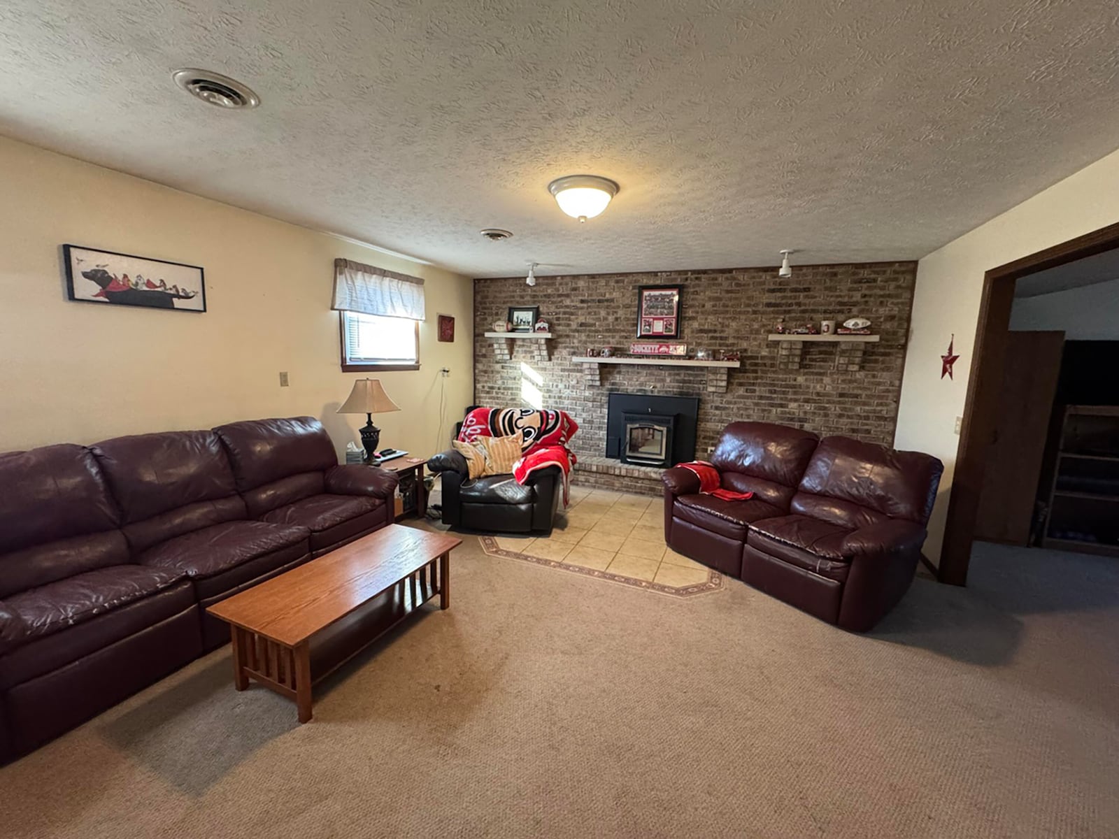 The lower level family room has a fireplace with new pellet stove insert and neutral carpeting