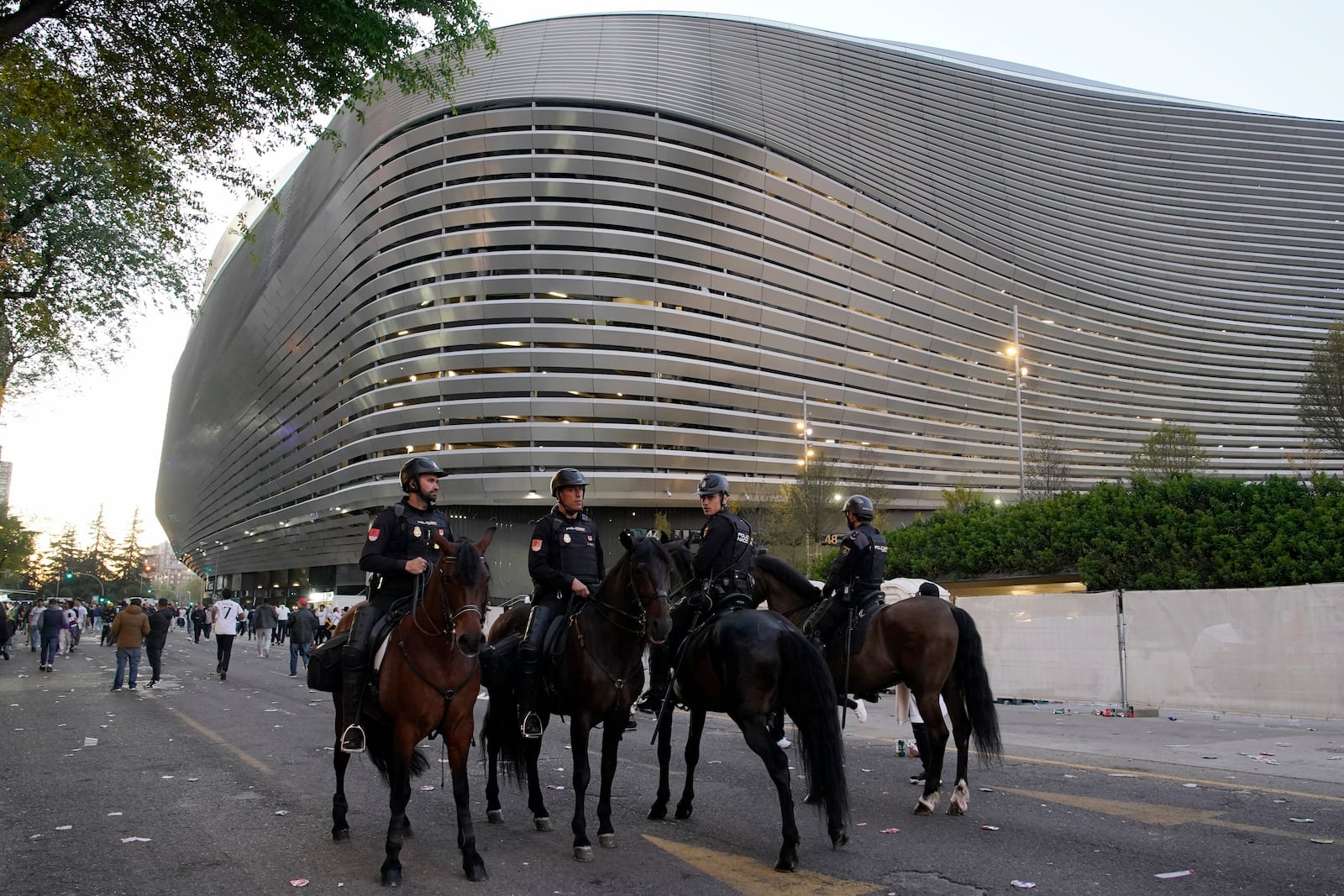 FILE - Police officers ride horses outside the Santiago Bernabeu stadium, ahead of the Champions League quarterfinal first leg soccer match between Real Madrid and Manchester City in Madrid, Spain, Tuesday, April 9, 2024. (AP Photo/Andrea Comas, File)