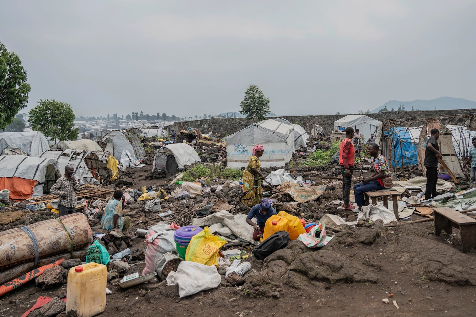 People who were displaced by the fighting between M23 rebels and government soldiers prepare to leave their camp following an instruction by M23 rebels in Goma, Democratic Republic of the Congo, Tuesday, Feb. 11, 2025. (AP Photo/Moses Sawasawa)