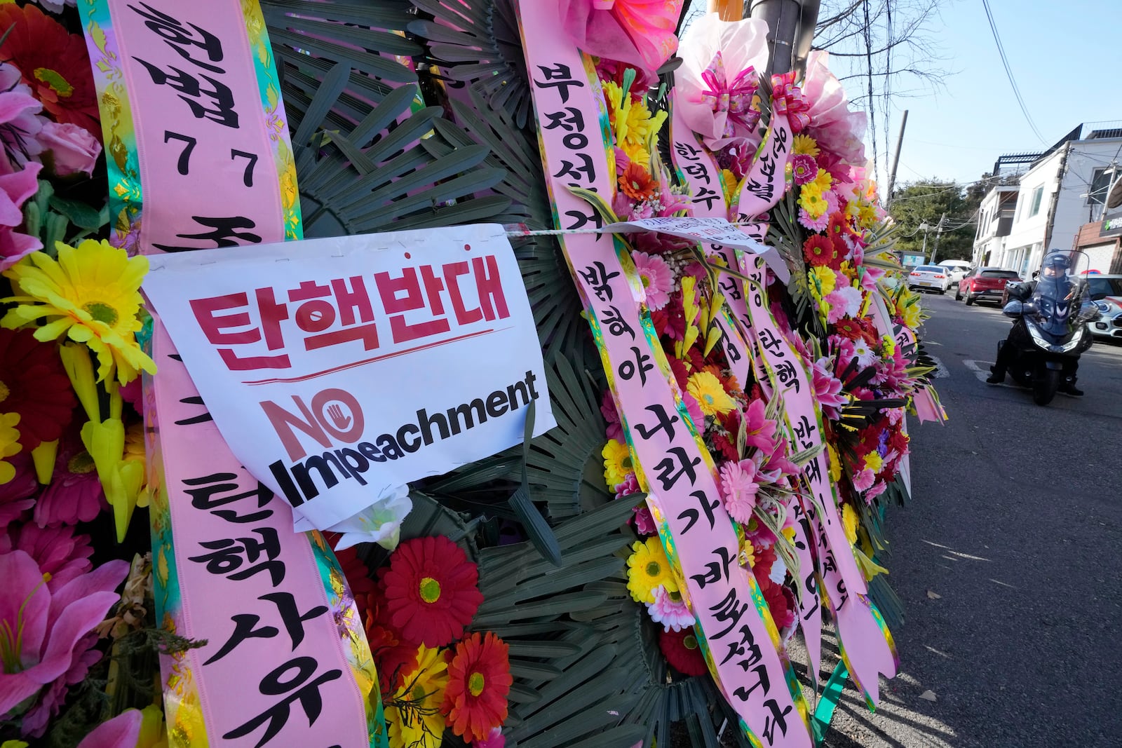 Wreaths sent by supporters of impeached South Korean President Yoon Suk Yeol are displayed outside the Constitutional Court in Seoul, South Korea, Friday, Dec. 27, 2024. (AP Photo/Ahn Young-joon)