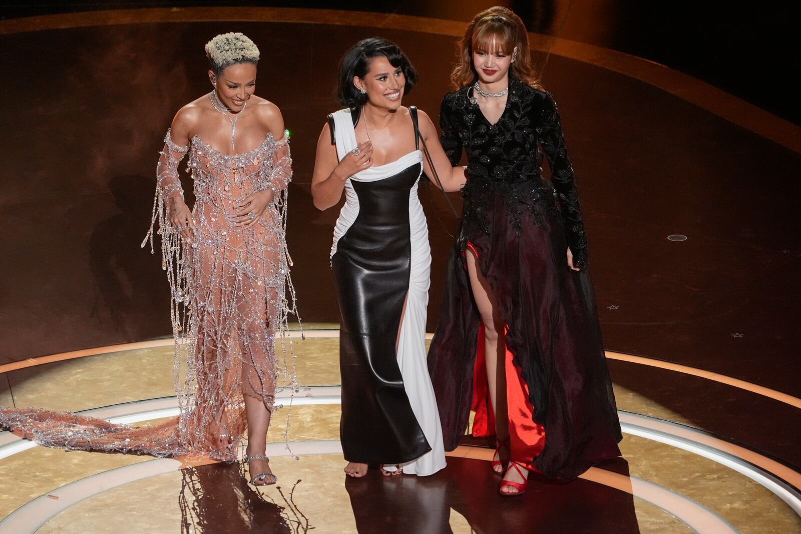 Doja Cat, from left, Raye, and Lisa on stage during the Oscars on Sunday, March 2, 2025, at the Dolby Theatre in Los Angeles. (AP Photo/Chris Pizzello)