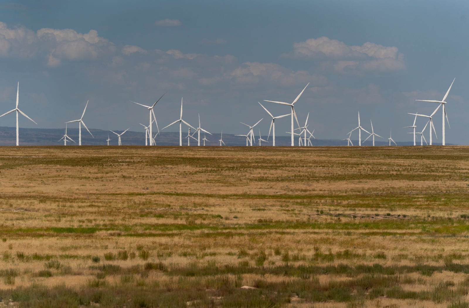 FILE - Wind turbines are seen from Interstate-84, Sunday, July 9, 2023, near Hammett, Idaho. (AP Photo/Lindsey Wasson, File)