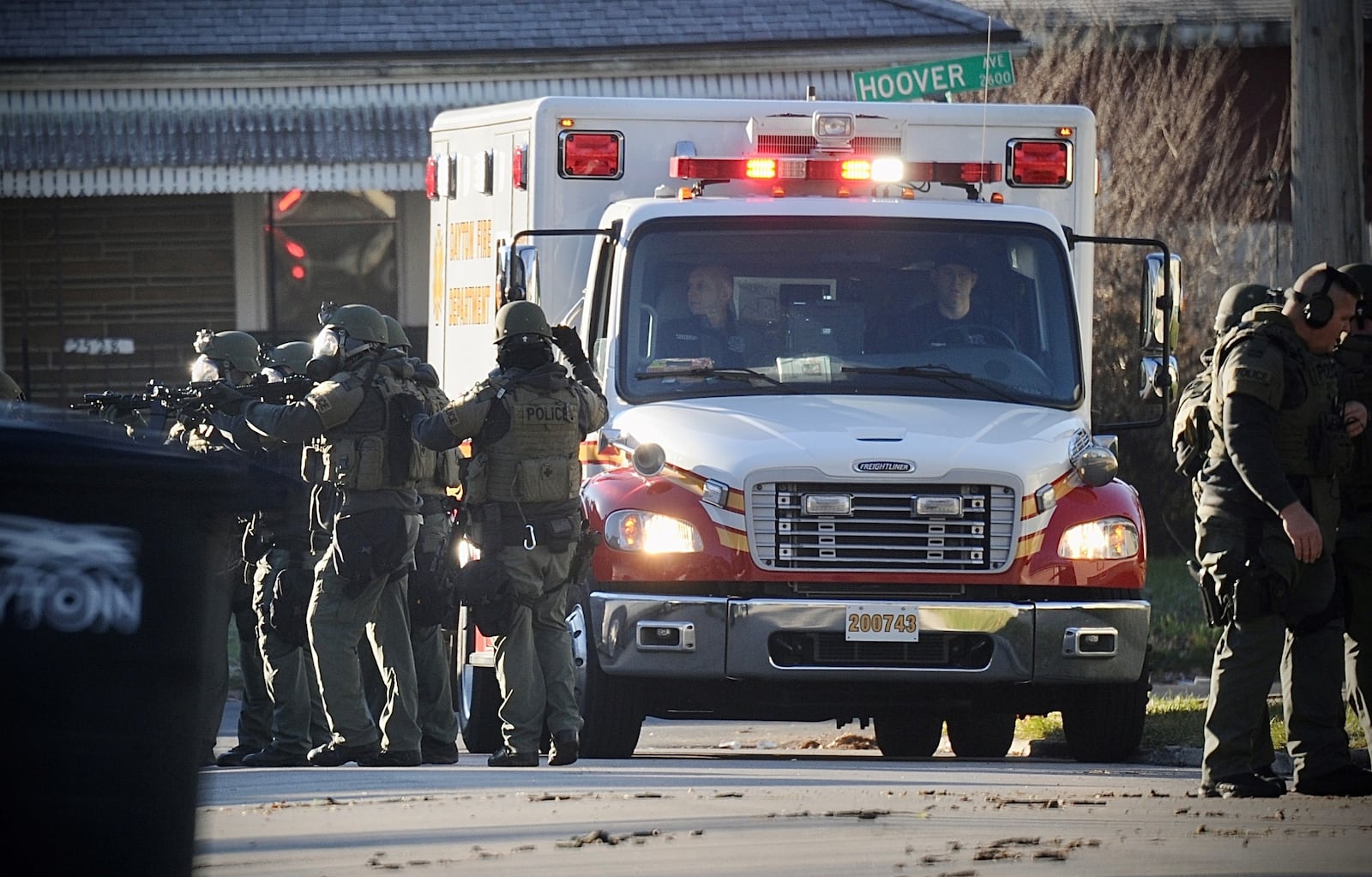 Dayton SWAT members have weapons drawn as an ambulance arrives after officers shot a 21-year-old man Tuesday, Dec. 14, 2021, near Hoover and Evergreen avenues. The man ran from  a house with a gun in his hand following a nearly three-hour standoff. Officers shot and killed the man.  MARSHALL GORBY/STAFF