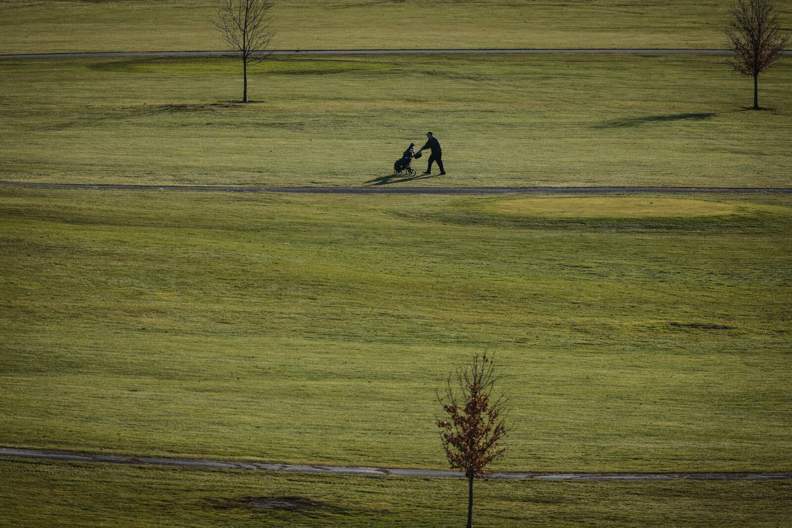 Alone golfer walks Community Golf Course on a warm December day in 2021. 2021 has been ranked one of warmest years  JIM NOELKER/STAFF