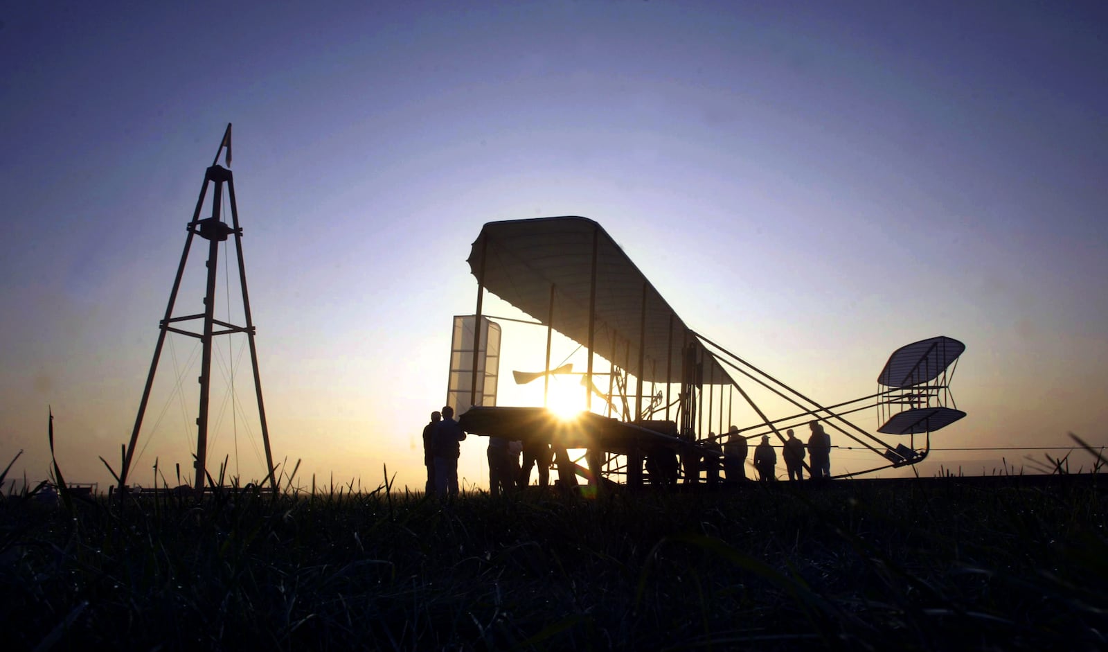 The crew for Mark Dusenberry, who made his own Wright Flyer III replica, prepares the plane for practice flights Tuesday morning. Dusenberry, from Denison, will fly Friday at the 102nd Anniversary of Practical, Powered Flight celebration at Huffman Prairie Flying Field. Staff photo by Chris Stewart