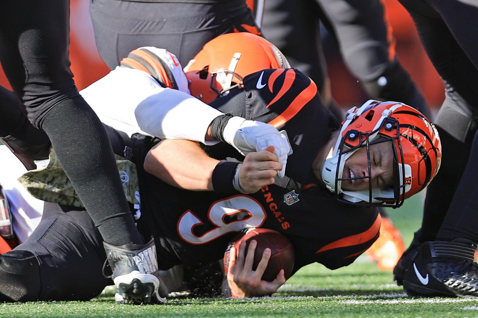 Cincinnati Bengals quarterback Joe Burrow (9) is sacked by Cleveland Browns' Myles Garrett during the second half of an NFL football game, Sunday, Nov. 7, 2021, in Cincinnati. (AP Photo/Aaron Doster)