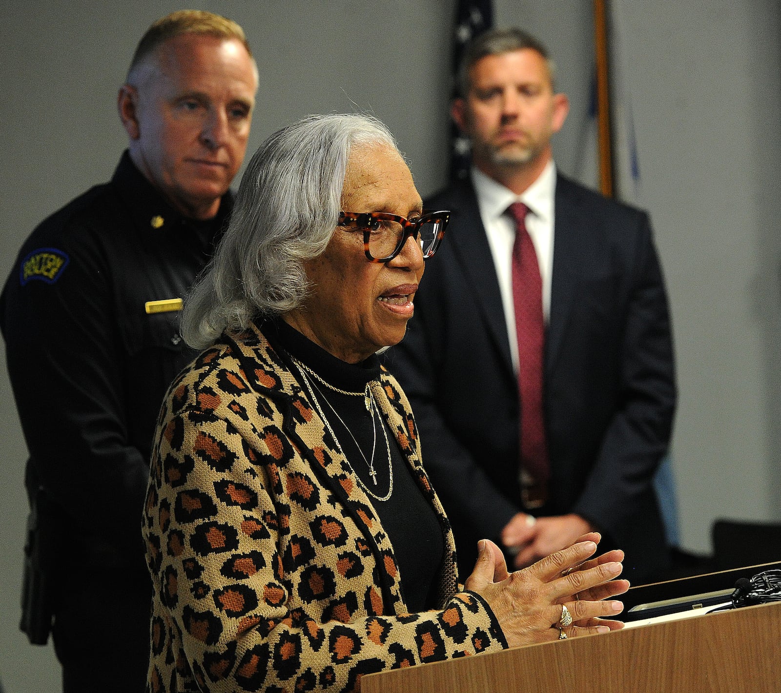 Rosemary Brame, the mother of Dayton police officer Kevin Brame who was gunned down in November 1999, speaks during a media briefing Thursday, April 11, 2024, at the Dayton Safety building. In back are Dayton police Maj. Brian Johns, left, and FBI Special Agent in Charge Adam Lawson. MARSHALL GORBY\STAFF