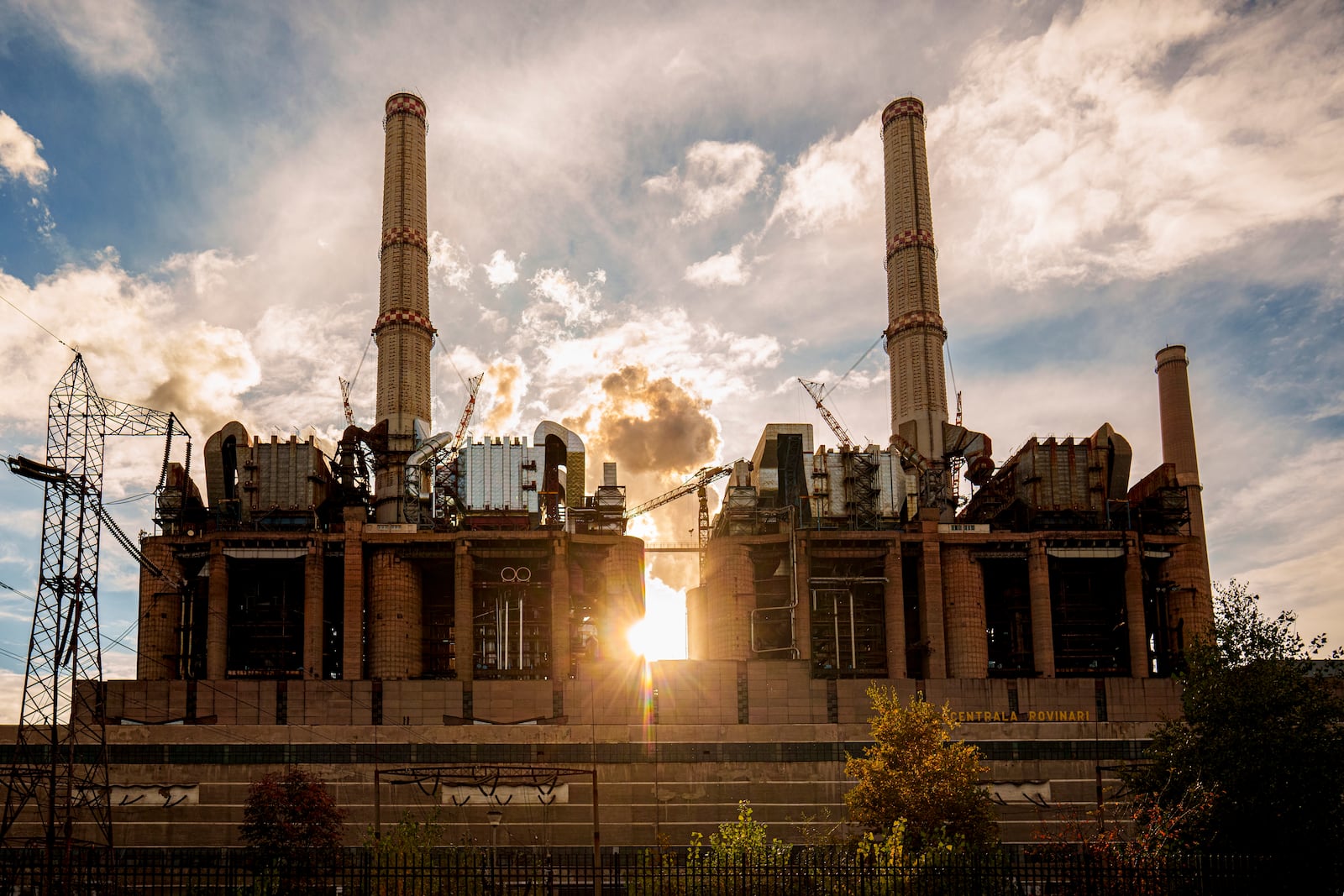 The sun sets behind Rovinari, a plant that produces electricity from coal, in Rovinari, southern Romania, Friday, Oct. 11, 2024. (AP Photo/Vadim Ghirda)