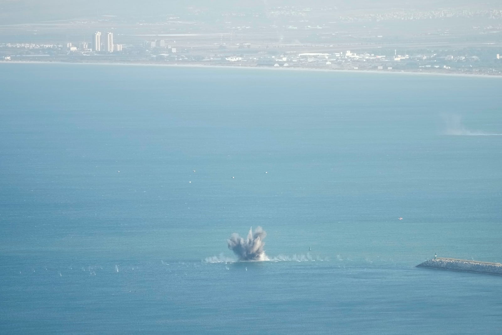 Rockets that were launched from Lebanon explode in the Mediterranean Sea as seen from Haifa, northern Israel, Friday, Nov. 8, 2024. (AP Photo/Francisco Seco)