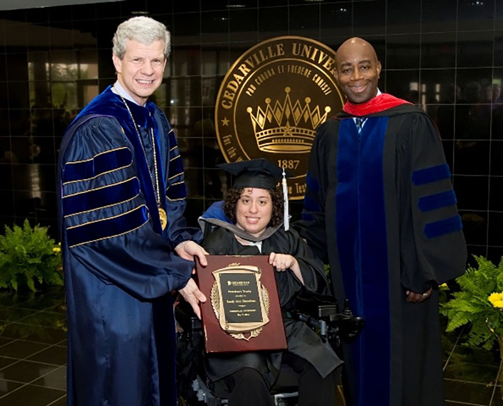 Emily (center) is awarded the President's Trophy, one of Cedarville University's most prestigious student awards and highest honor for a graduating senior in 2011. L-R Dr. William E. Brown, Emily, Rear Admiral Barry C. Black