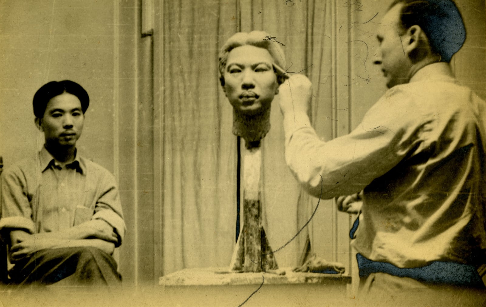 Robert Koepnick pictured at work in his studio. The finished bust is on display next to this photo.