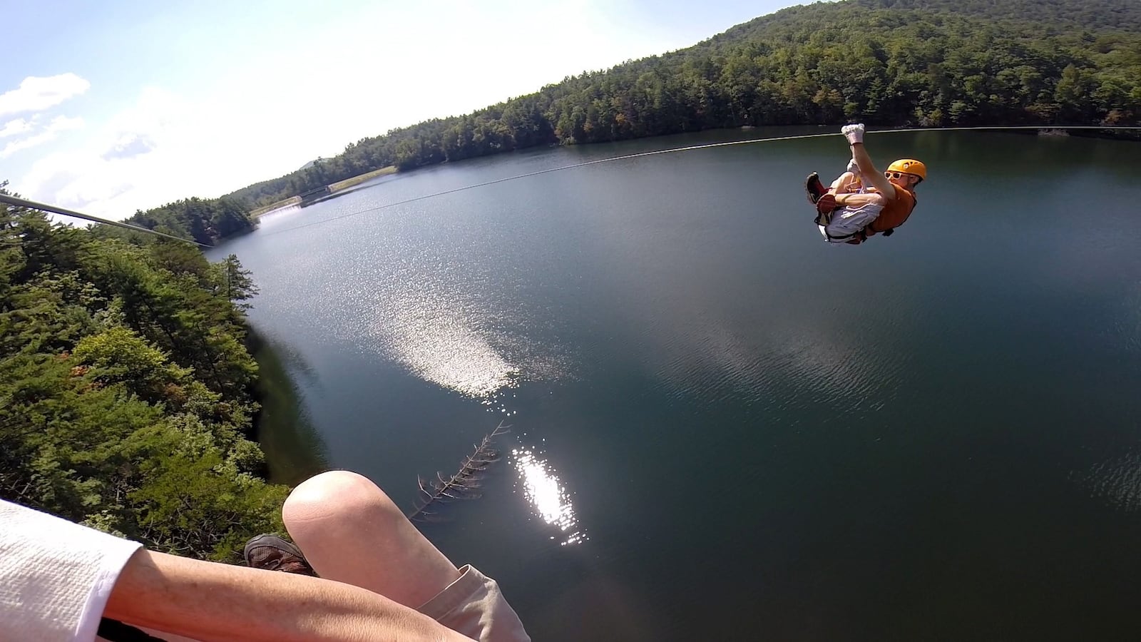 Jason Beck, a zipline guide at Unicoi Aerial Adventure Park, leans back to accelerate as he crosses Smith Lake on the longest of Unicoi's ziplines.