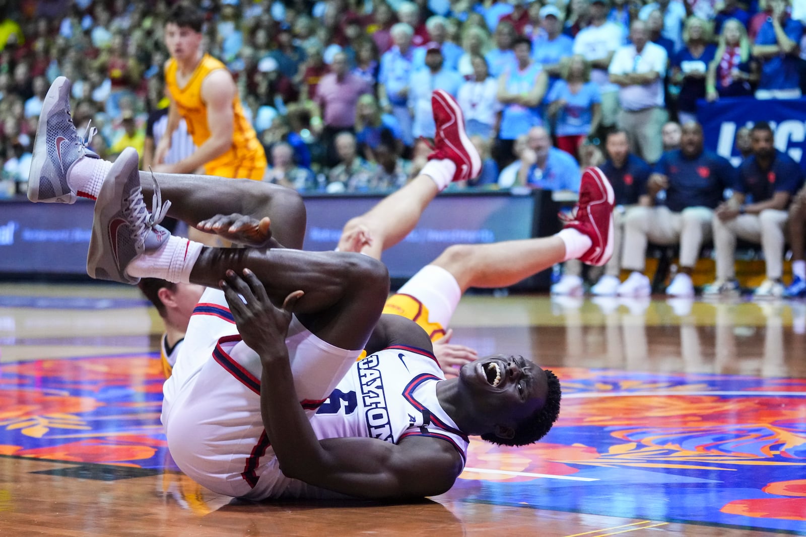 Dayton guard Enoch Cheeks holds his ankle after a collision against Iowa State during the second half of an NCAA college basketball game at the Maui Invitational Tuesday, Nov. 26, 2024, in Lahaina, Hawaii. Iowa State won 89-84. (AP Photo/Lindsey Wasson)