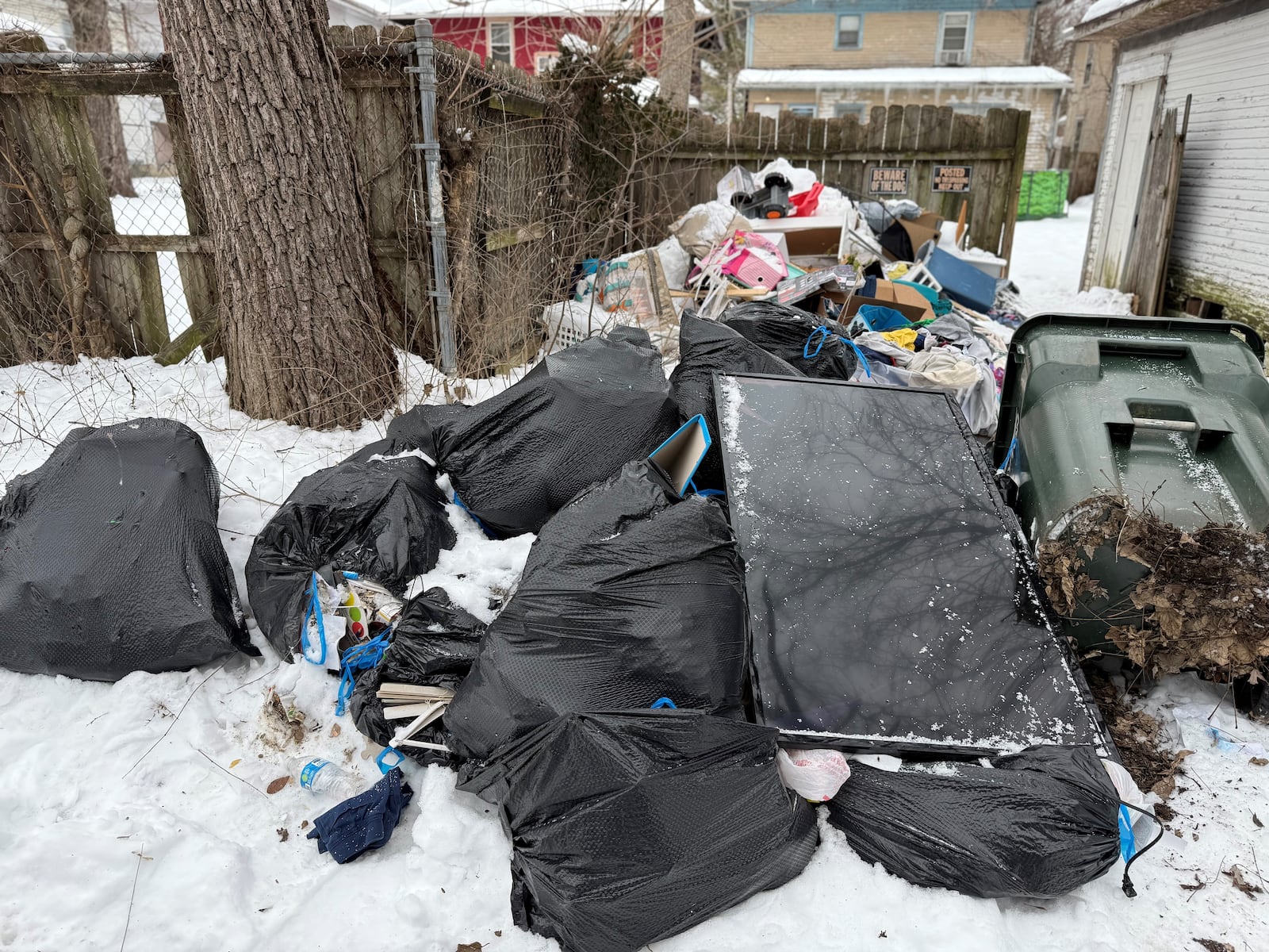 A mound of trash in the alley behind homes on Grafton and Rockwood avenues in Dayton's Grafton Hill neighborhood. CORNELIUS FROLIK / STAFF