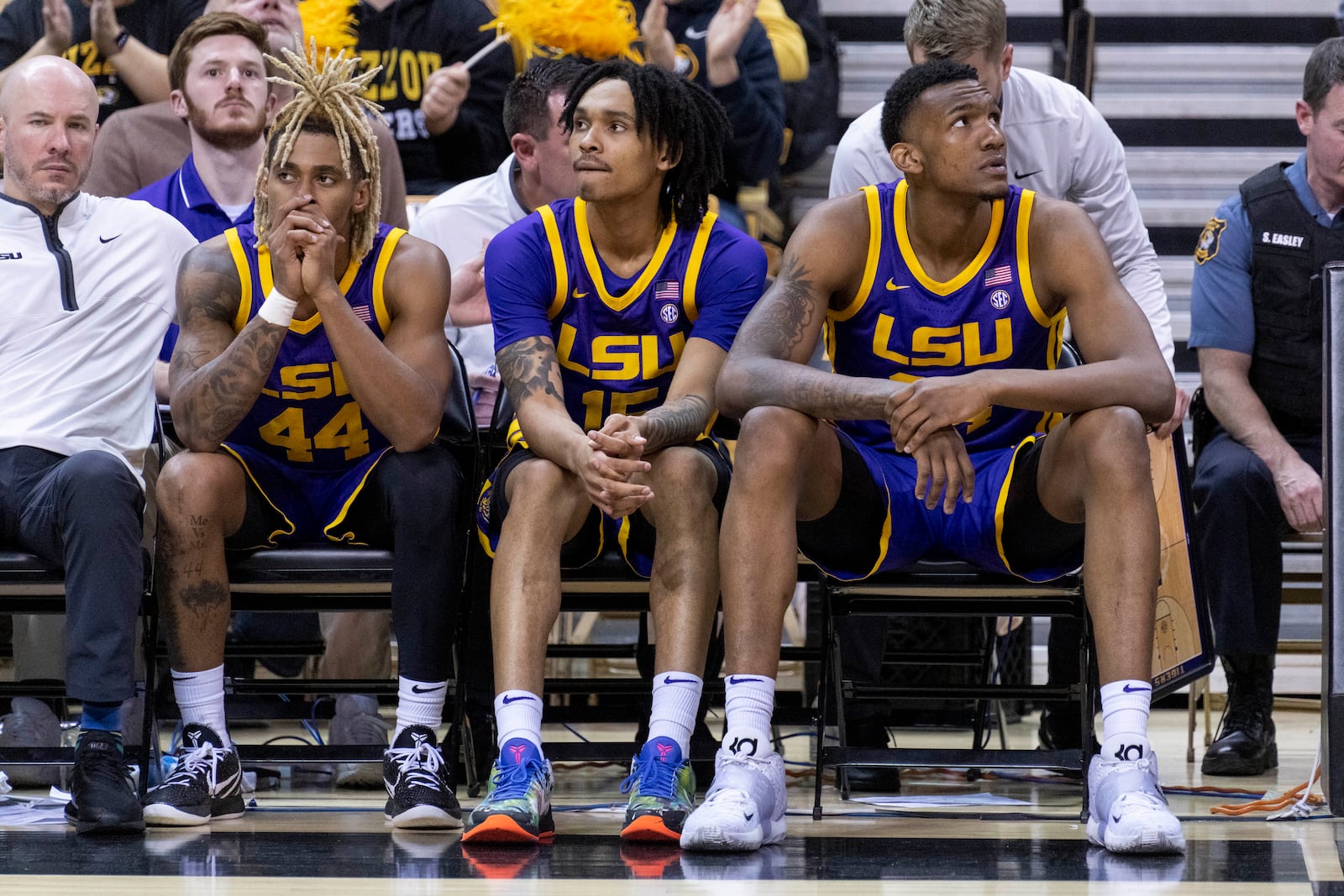 LSU's Adam Miller, left, Tyrell Ward, Shawn Phillips, right, sit on the bench during the final minute in second half of an NCAA college basketball game against Missouri Wednesday, Feb. 1, 2023, in Columbia, Mo. Missouri won 87-77.(AP Photo/L.G. Patterson)