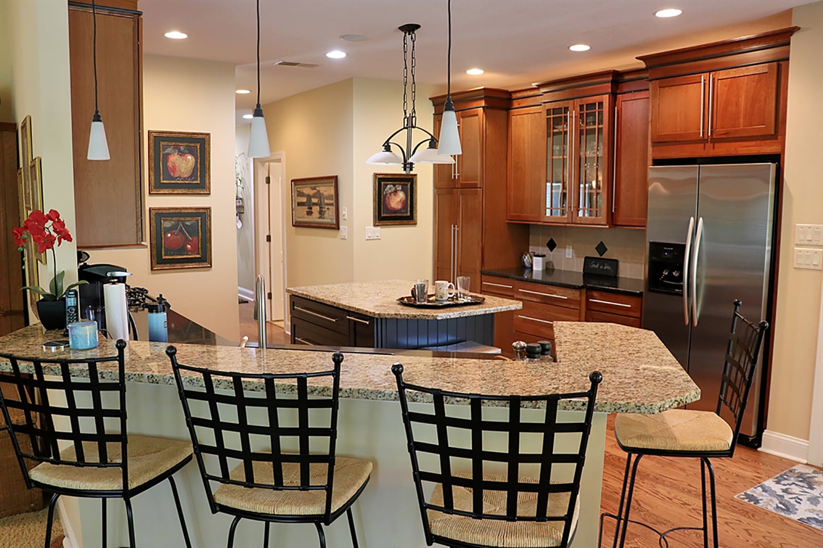 A combination of light and dark granite countertops offer plenty or preparation space in the kitchen. The dual-level peninsula counter has a light granite bar and dark counter where the double sink and gas range are built-in. An island has storage and additional seating. CONTRIBUTED PHOTO BY KATHY TYLER