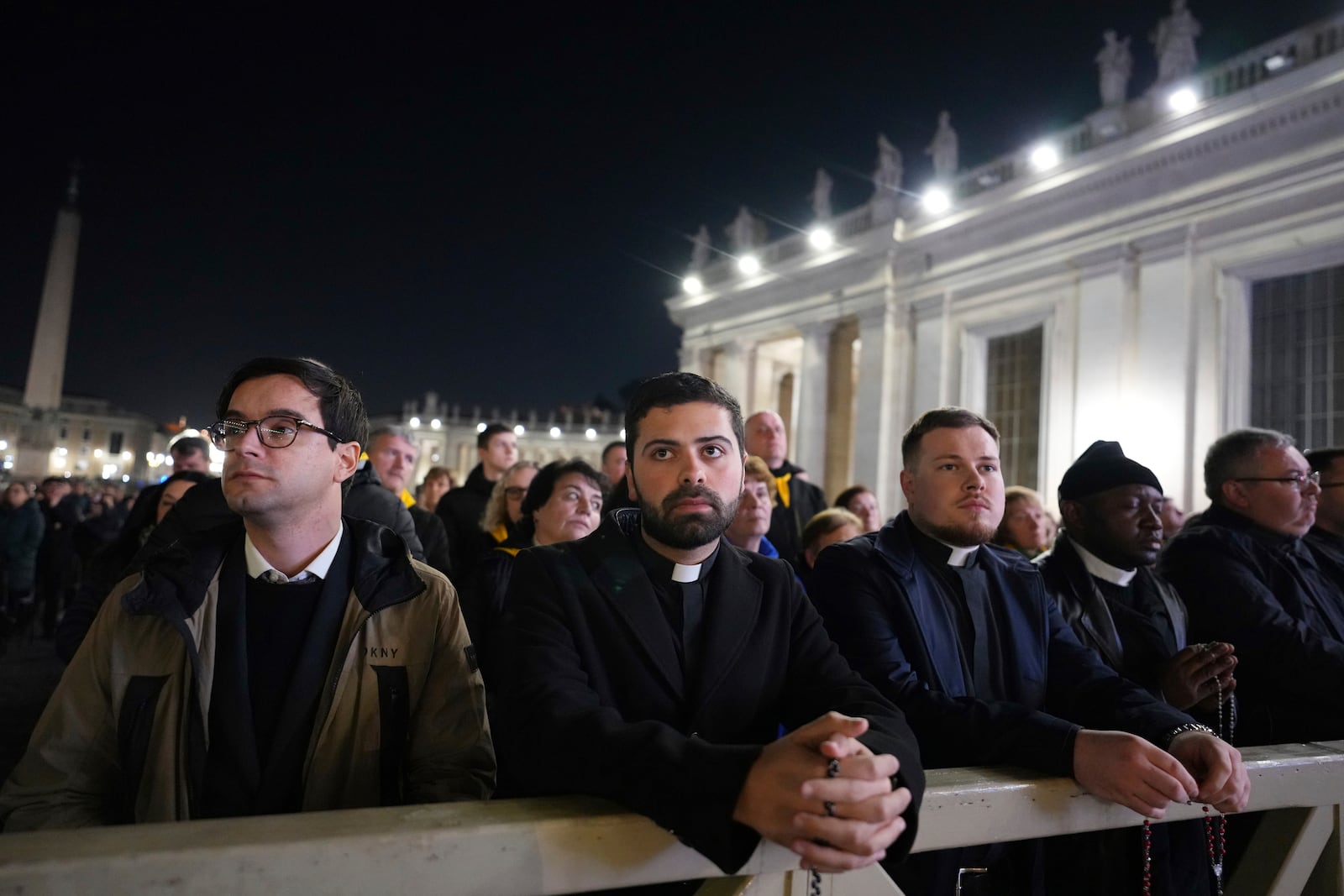 People attend as Cardinal Robert Francis Prevost, Prefect of the Dicastery for Bishops, leads the recitation of the Holy Rosary for Pope Francis' health in St Peter's Square at the Vatican, Monday, March 3, 2025. (AP Photo/Kirsty Wigglesworth)