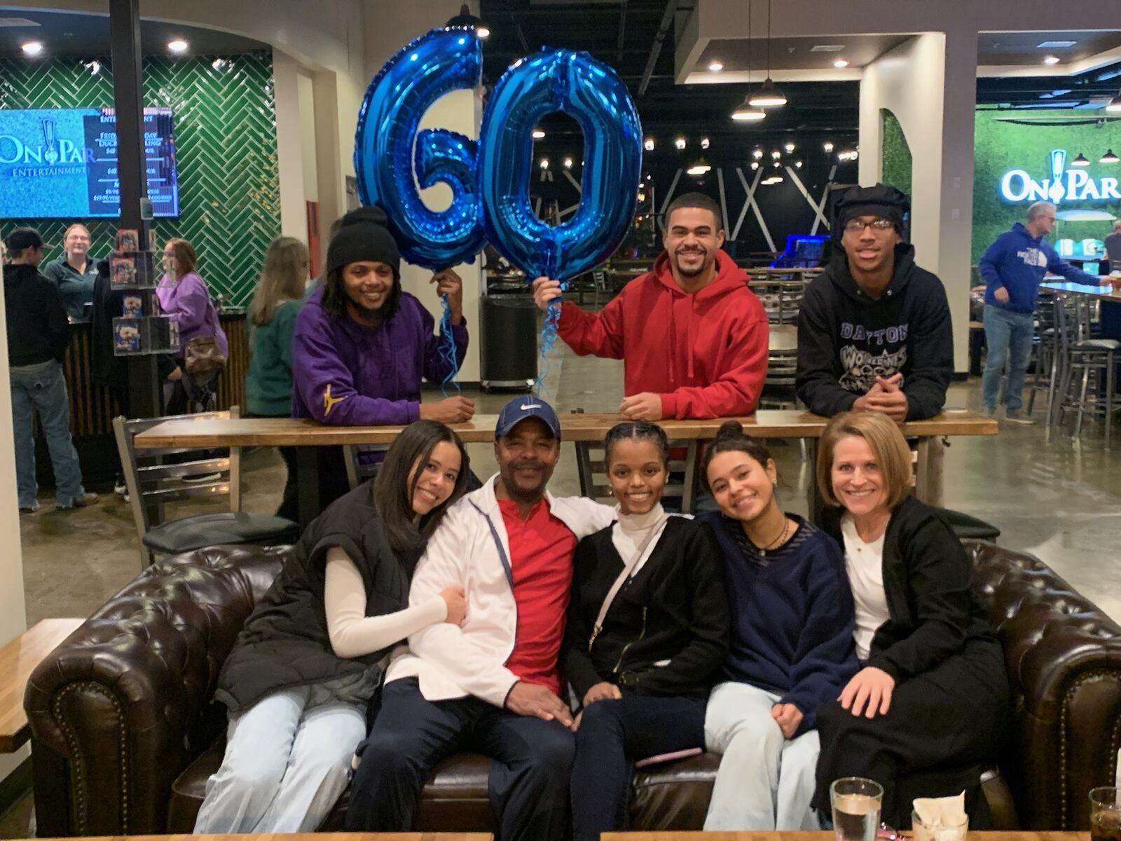 David Reynolds  (seated with red t-shirt) with his family at his 60th birthday party in early December. (Front row, left to right)  daughter Dani; David; daughter Courtney; daughter Maya and wife Kate. (back row left to right) son Denzel; son Darian;  and grandson Kasaun. CONTRIBUTED