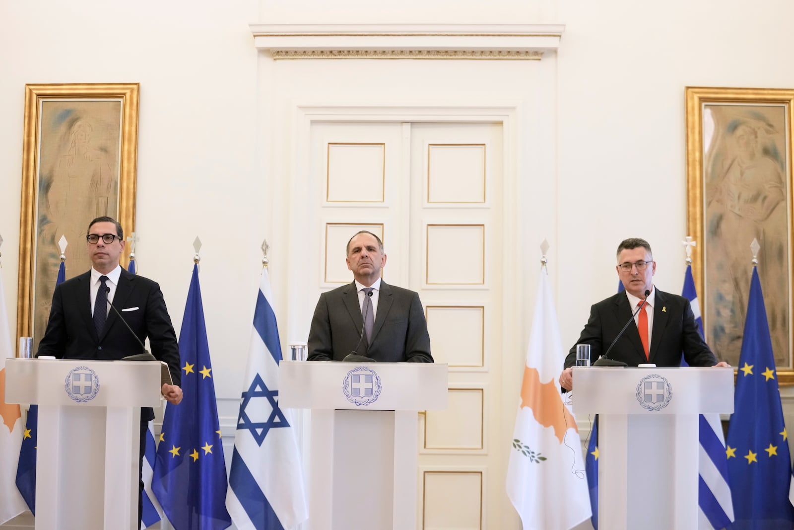 Israel's Foreign Minister Gideon Sa'ar, right, speaks next to Greece' Foreign minister Giorgos Gerapetritis, centre, and Cyprus' Foreign Minister Constantinos Kombos, during a news conference following a trilateral meeting on energy cooperation in Athens, Thursday, March 13, 2025. (AP Photo/Petros Giannakouris)