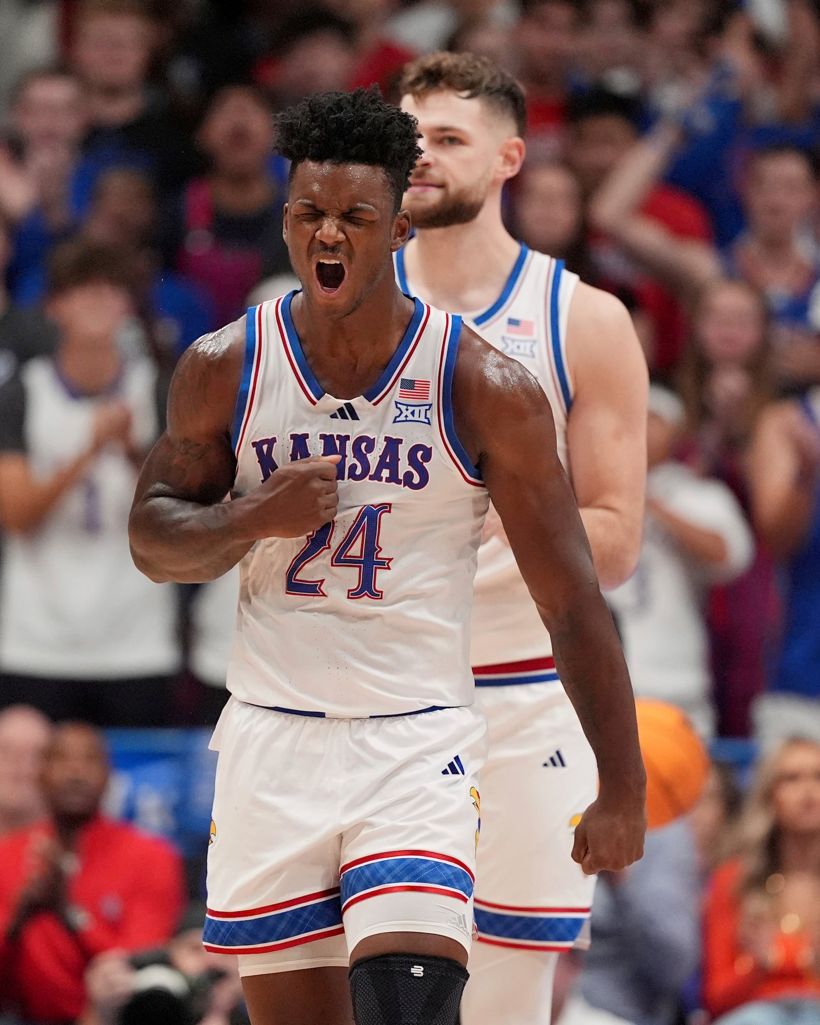 Kansas forward KJ Adams Jr. celebrates after making a basket during the first half of an NCAA college basketball game against North Carolina Friday, Nov. 8, 2024, in Lawrence, Kan. (AP Photo/Charlie Riedel)