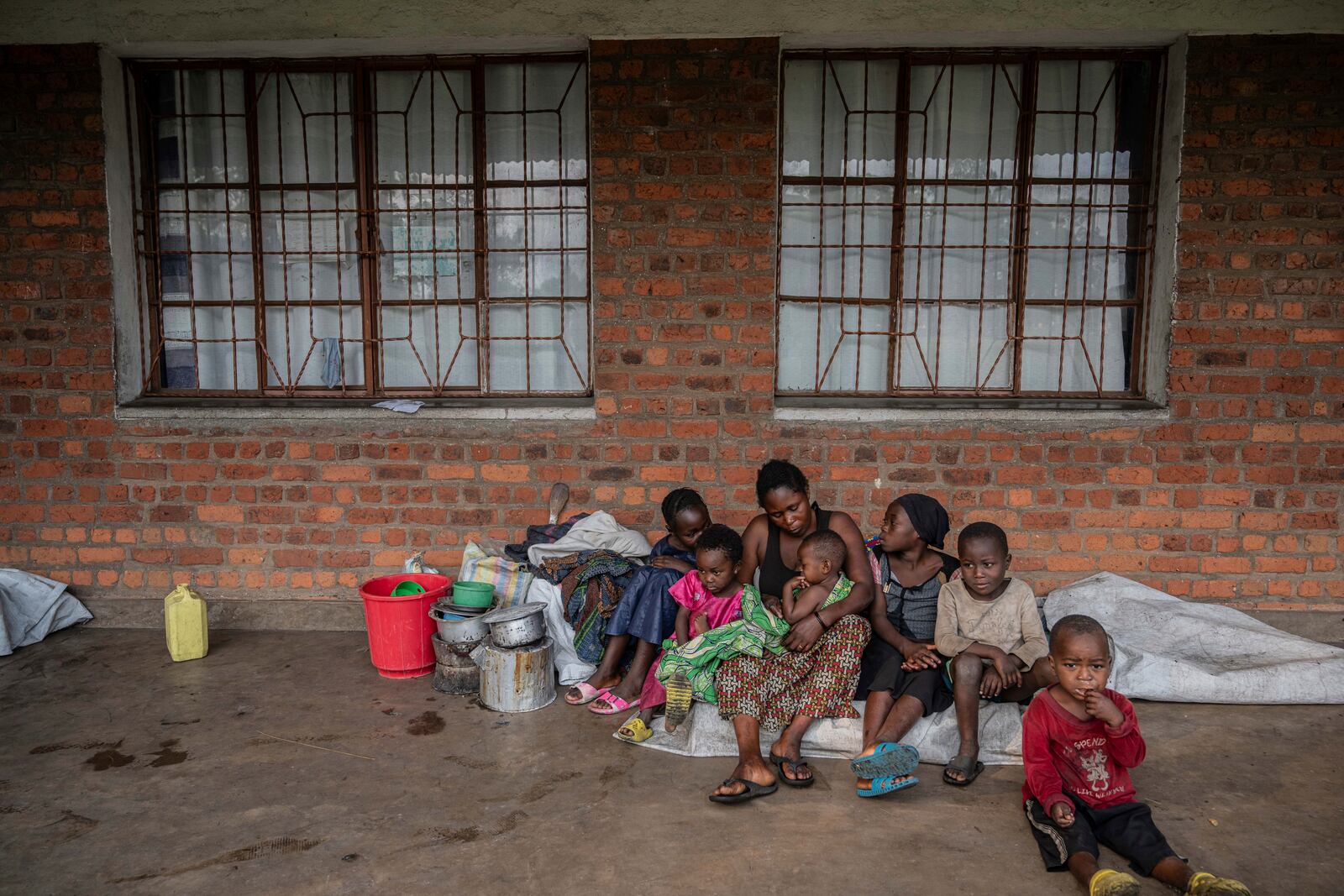 Zawadi Sifa, 35, who has been fleeing fighting from camp to camp, sits with her seven children at her latest displaced camp in Goma, Democratic Republic of the Congo, Thursday, Feb. 5, 2025.(AP Photo/Moses Sawasawa)