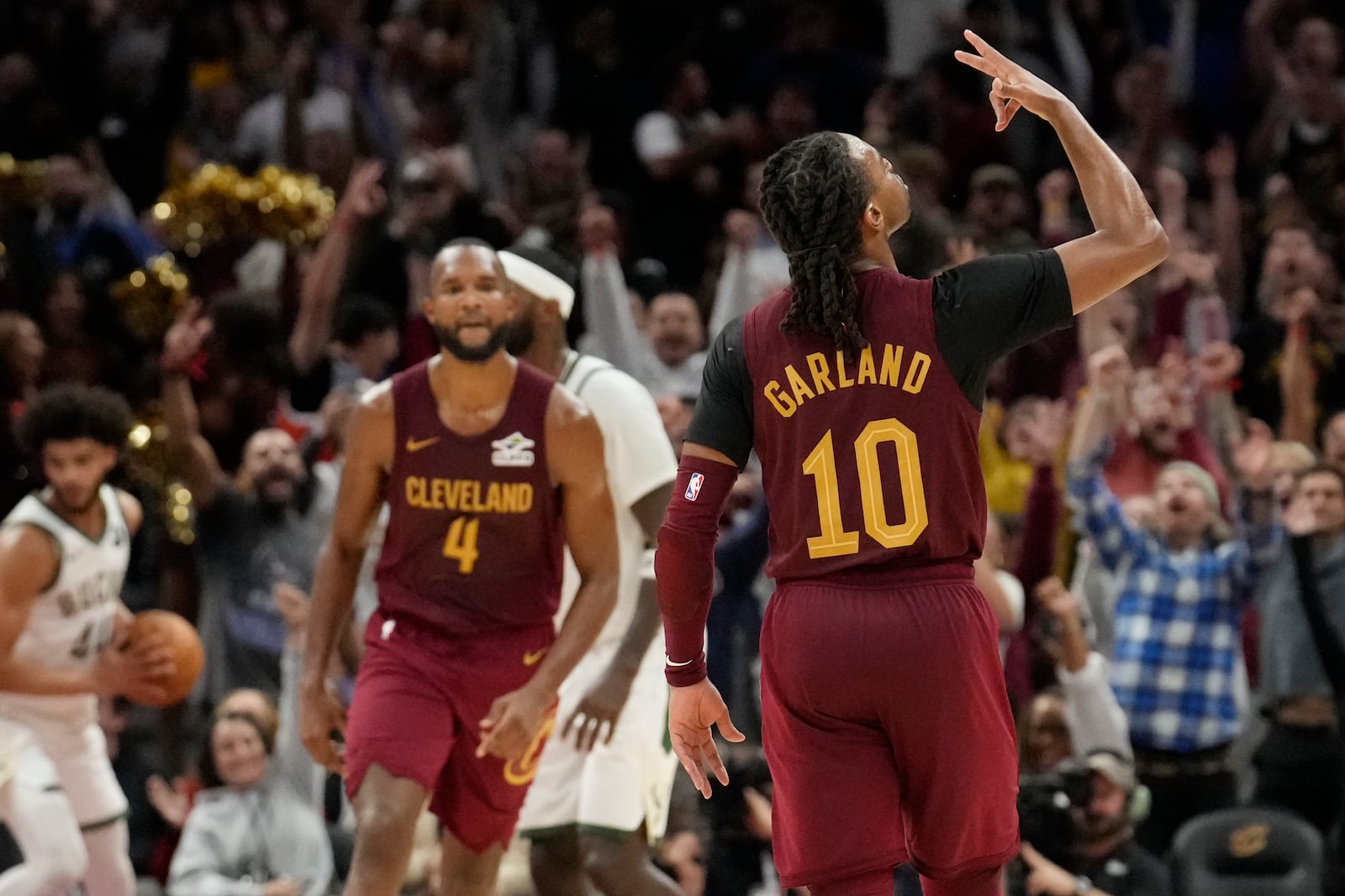 Cleveland Cavaliers guard Darius Garland (10) gestures after a basket late in the second half of an NBA basketball game against the Milwaukee Bucks, Monday, Nov. 4, 2024, in Cleveland. forward Evan Mobley (4) is at center. (AP Photo/Sue Ogrocki)