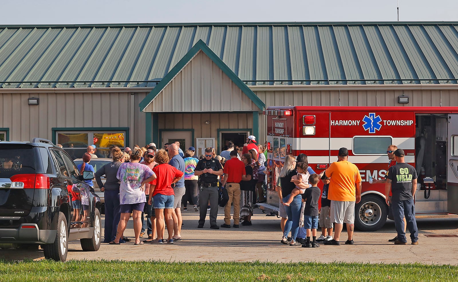 Families wait outside the German Township Government Center to be reunited with their children following the Northwestern School District bus crash on Route 41 Tuesday, August 22, 2023. BILL LACKEY/STAFF