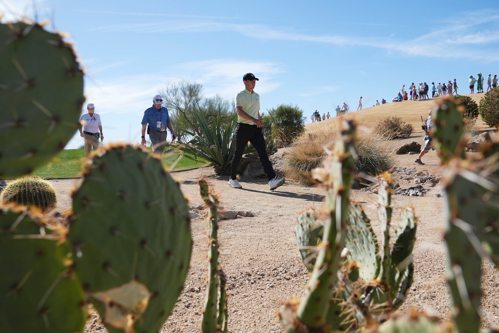 Jordan Spieth walks through the desert to get to the fourth green during the third round of the Phoenix Open golf tournament at TPC Scottsdale, Saturday, Feb. 8, 2025, in Scottsdale, Ariz. (AP Photo/Ross D. Franklin)