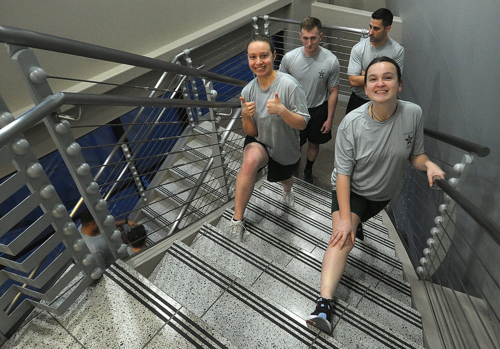 Reporter London Bishop, left, and cadet Katie Wise stretch their legs on the stairs before morning physical training, Thursday, Jan. 11, 2024. MARSHALL GORBY\STAFF