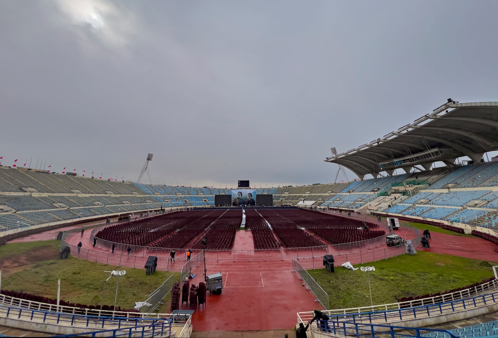 Workers set the chairs at Beirut's City Sportive stadium during preparation, a day ahead of the funeral procession of Hezbollah leaders Sayyed Hassan Nasrallah and Sayyed Hashem Safieddine, in Beirut, Lebanon, Saturday, Feb. 22, 2025. (AP Photo/Hussein Malla)