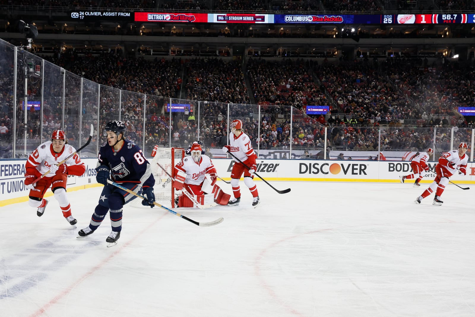 Detroit Red Wings' Albert Johansson, left, and Columbus Blue Jackets' Mikael Pyyhtia chase the puck during the second period of the Stadium Series NHL hockey game at Ohio Stadium, Saturday, March 1, 2025, in Columbus, Ohio. (AP Photo/Jay LaPrete)