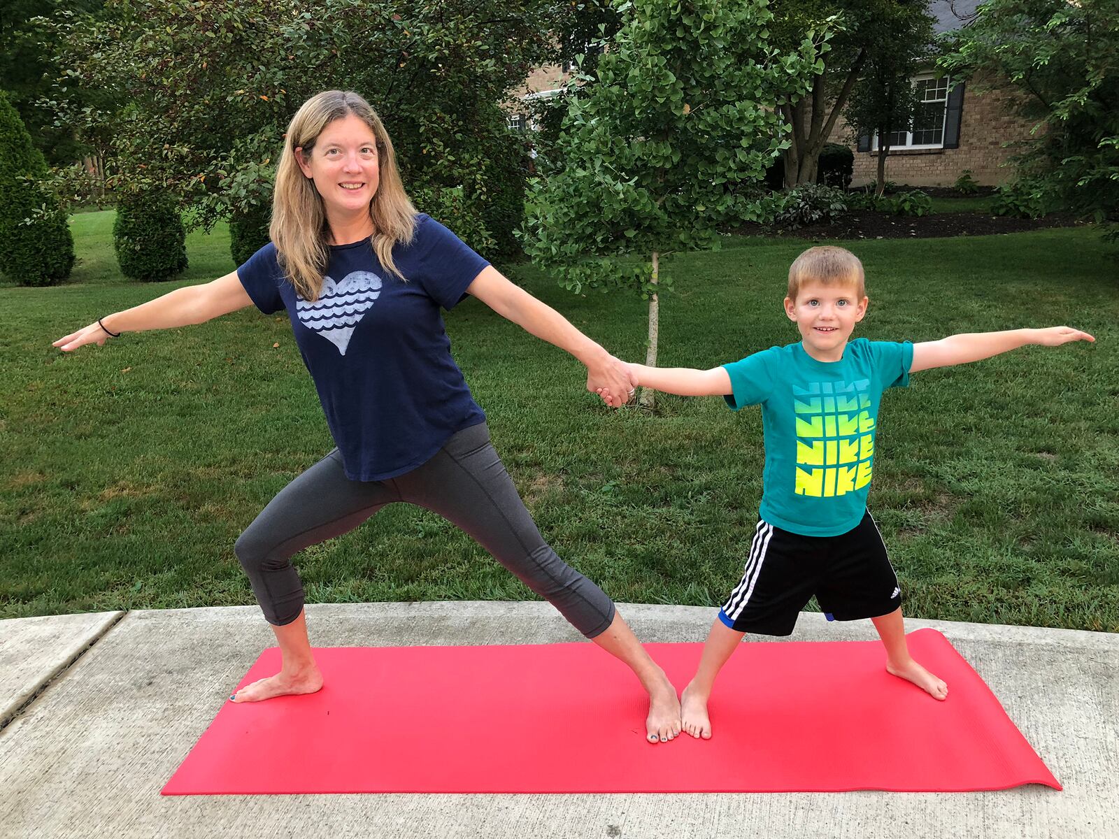 Elissa Dinsmore with her younger son, Owen, age 8. She said practicing yoga together has truly helped both of them, especially throughout the global pandemic. CONTRIBUTED