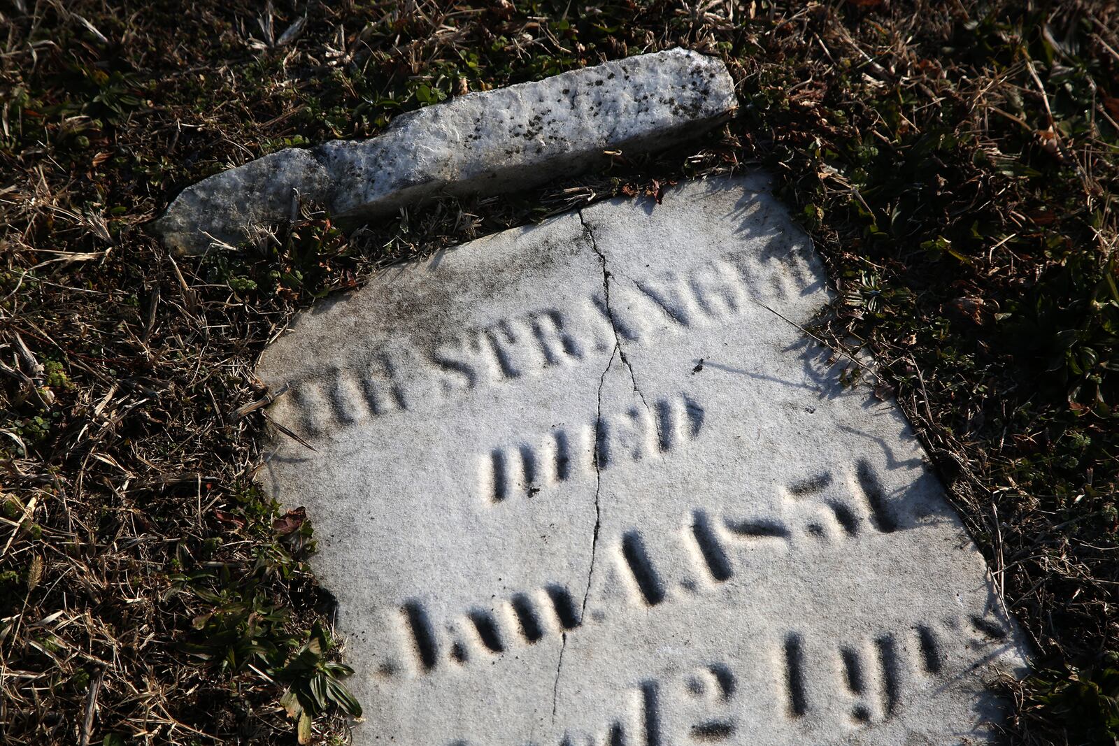 A tombstone labeled “THE STRANGER” marks the grave of a young woman at Old Greencastle Cemetery in Dayton. LISA POWELL / STAFF