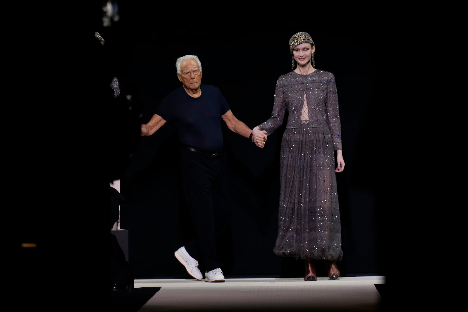 Giorgio Armani acknowledges the applause at the end of the Giorgio Armani Fall/Winter 2025-2026 Women's collection presented in Milan, Italy, Sunday, March 2, 2025. (AP Photo/Luca Bruno)