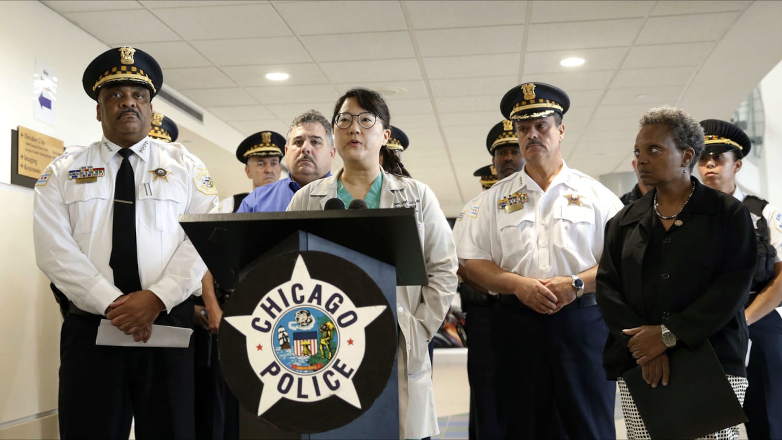 Trauma surgeon Dr. Jane Kayle Lee, at podium, gives reporters a status update on a Chicago police officer shot Saturday, Sept. 21, 2019, trying to arrest Michael Blackman. Blackman, 45, is a suspect in the shooting of a woman three days earlier.