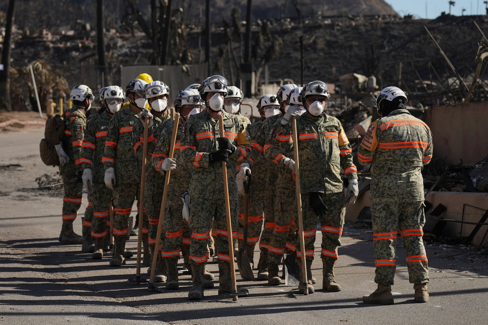 Search and rescue crew from Mexico inspect a mobile home park destroyed by the Palisades Fire in Palisades, Calif. is seen, Wednesday, Jan. 15, 2025. (AP Photo/Jae C. Hong)