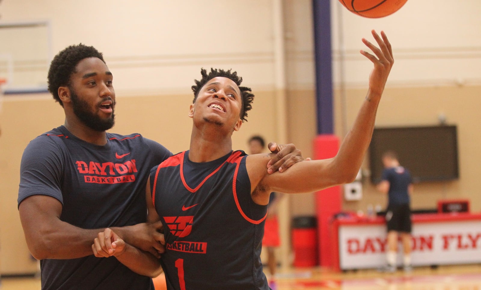 Dayton’s Josh Cunningham and Darrell Davis joke around as they warm up for practice on Thursday, Sept. 21, 2017, at the Cronin Center in Dayton.