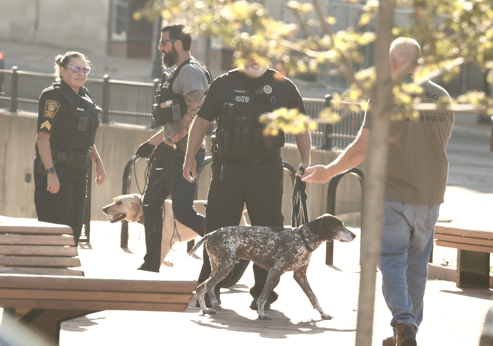 Two Dayton K-9 units search the Springfield City Hall on Thursday after the building was evacuated due to a threat. BILL LACKEY/STAFF