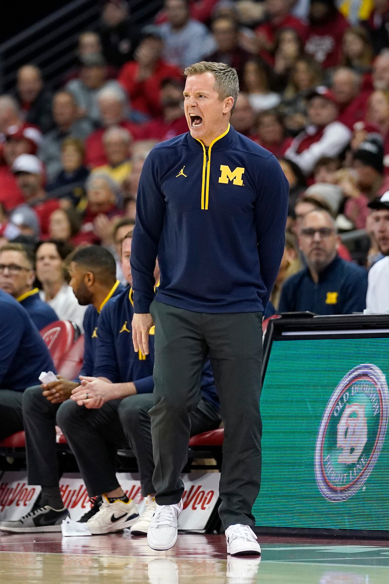 Michigan head coach Dusty May yells to his players during the first half of an NCAA college basketball game against Wisconsin, Tuesday, Dec. 3, 2024, in Madison, Wis. (AP Photo/Kayla Wolf)