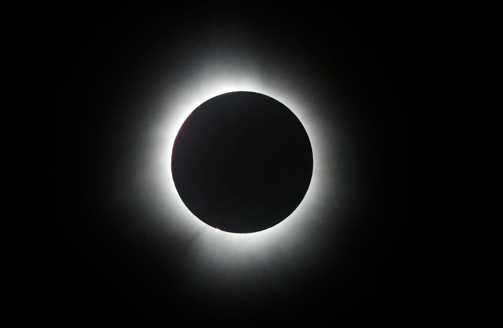 The total eclipse Monday, April 8, 2024 over National Road Commons Park in Springfield. BILL LACKEY/STAFF