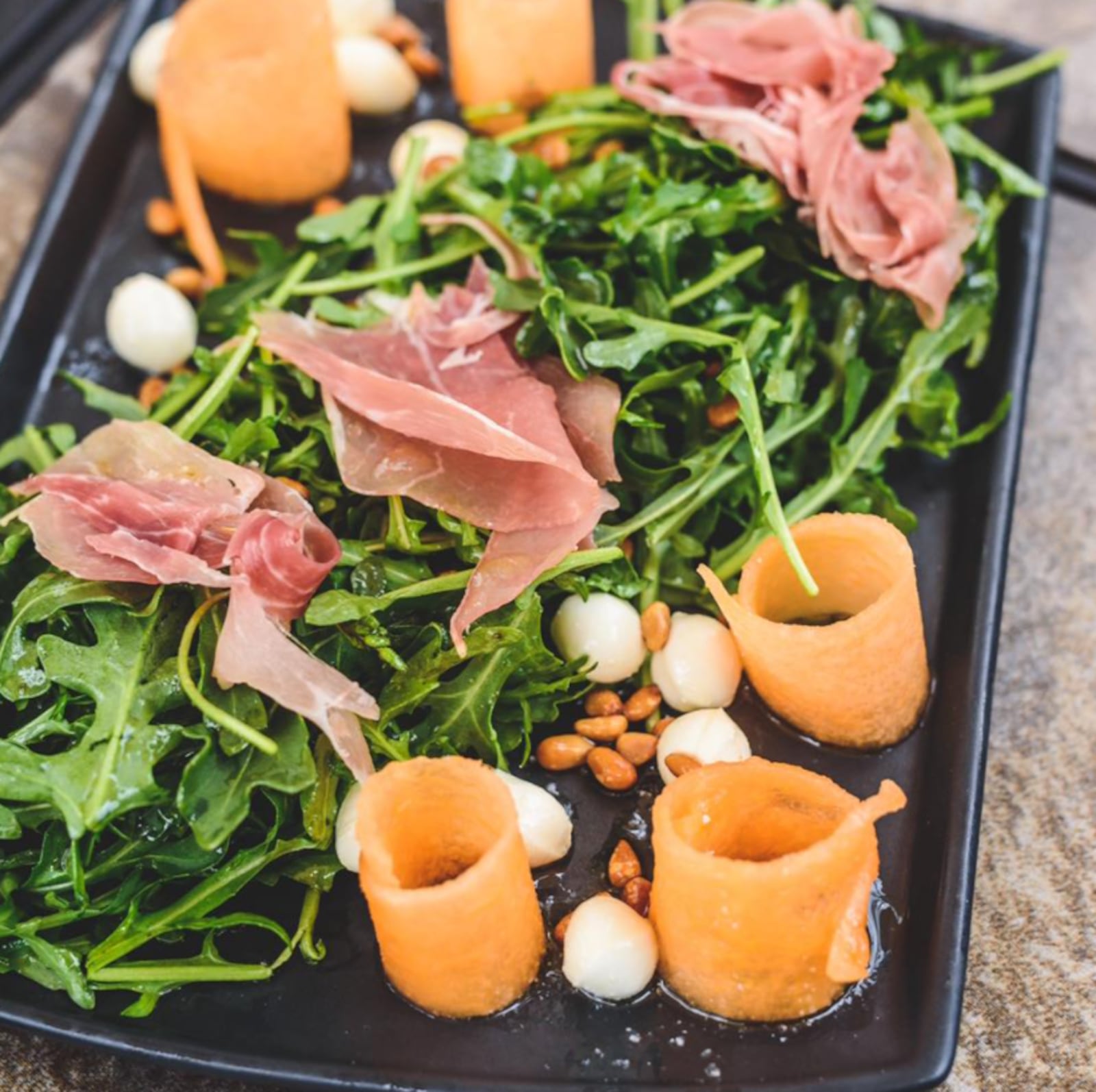 Salar's Summer Cantaloupe Salad: Arugula, cantaloupe, toasted pine nuts,  topped with prosciutto and tossed in a basil vinaigrette. CONTRIBUTED