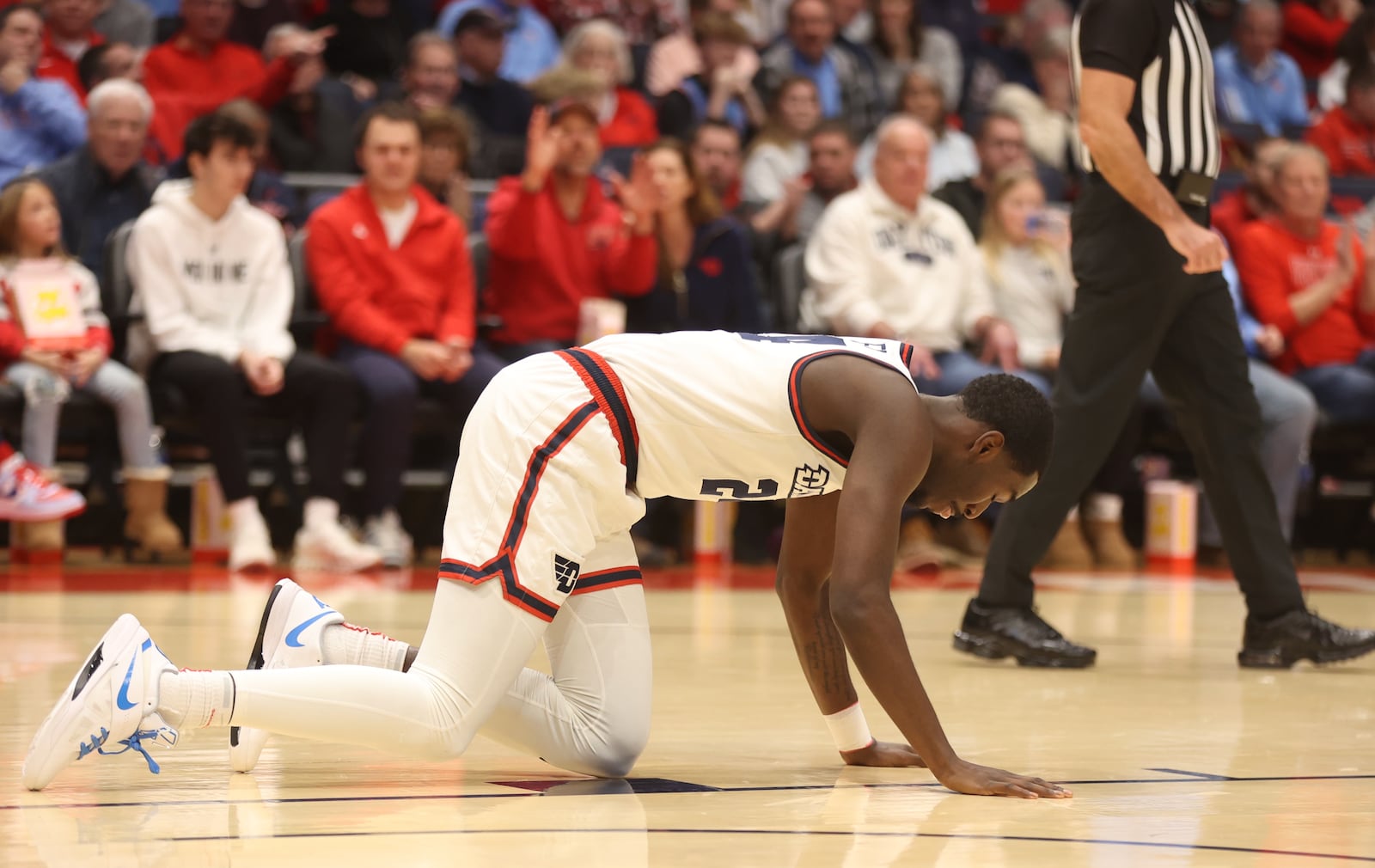 Dayton's Kobe Elvis gets up after suffering an injury in the first half against Massachusetts on Sunday, Jan. 7, 2024, at UD Arena. David Jablonski/Staff