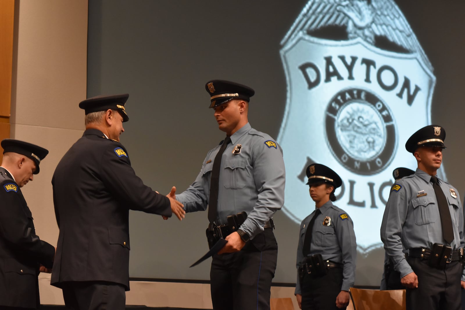 Dayton police Chief Kamran Afzal hands out diplomas to 15 police recruits who graduated from the police academy on Nov. 17, 2023. CORNELIUS FROLIK / STAFF