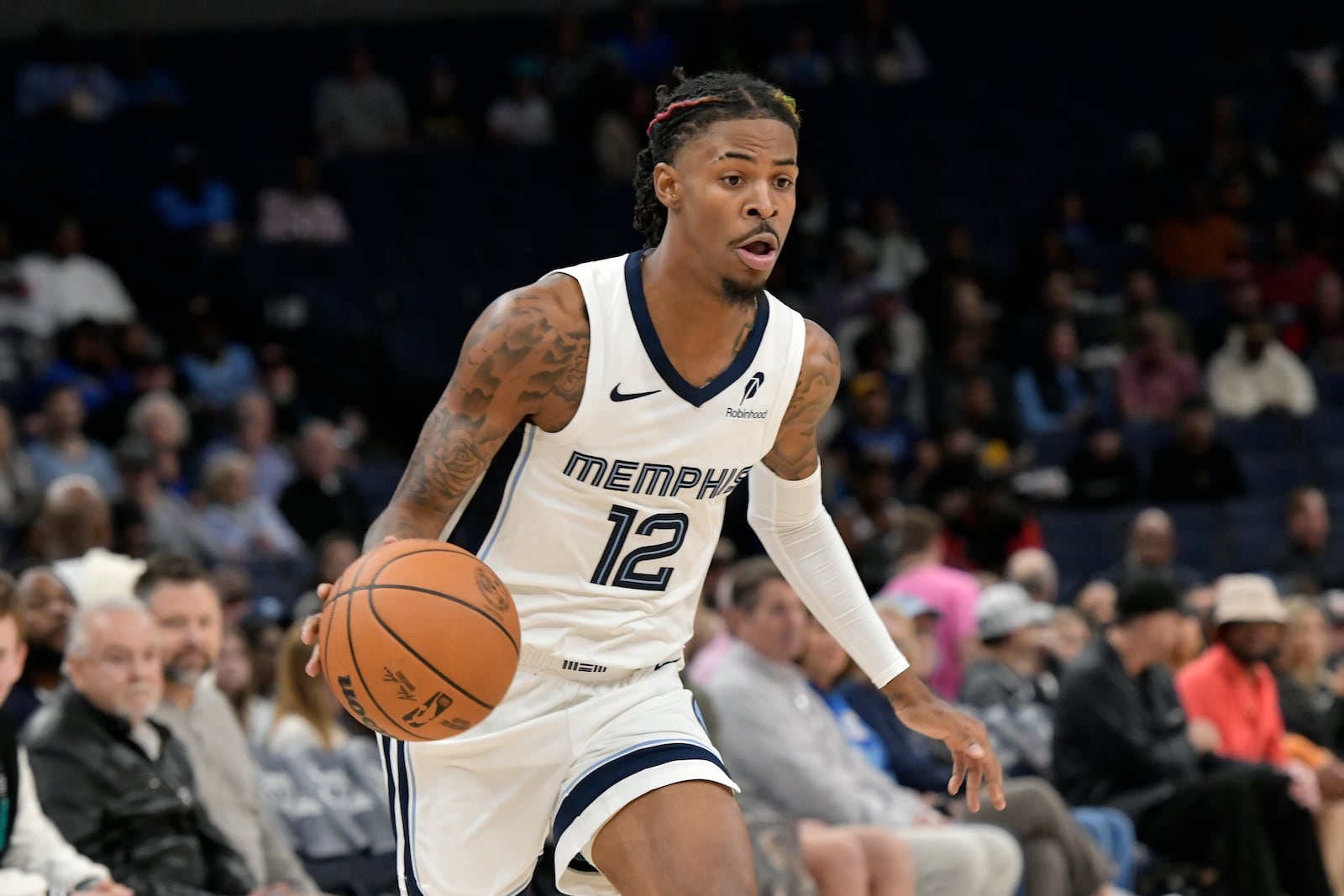 Memphis Grizzlies guard Ja Morant handles the ball against the Miami Heat in the first half of an NBA preseason basketball game Friday, Oct. 18, 2024, in Memphis, Tenn. (AP Photo/Brandon Dill)