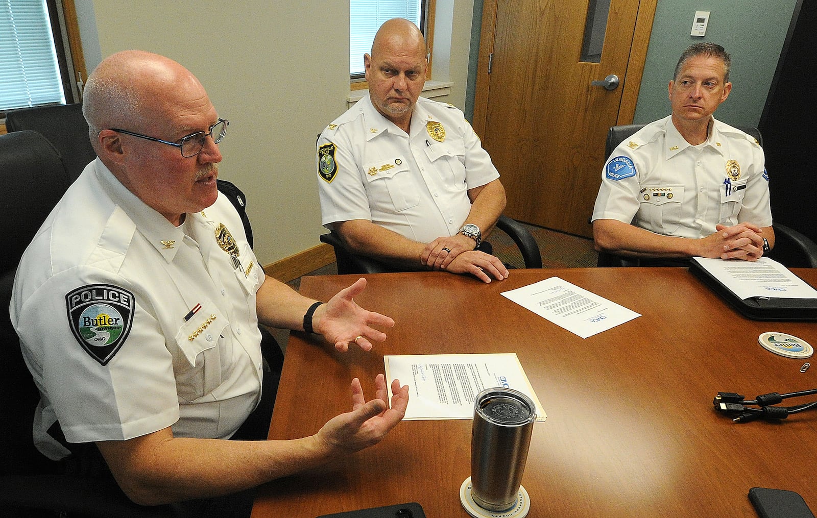 Butler Township Chief of Police John Porter (left), Brookville Chief of Police Douglas Jerome (middle) and Vandalia Chief of Police Kurt Althouse, each of of the Montgomery County Association of Police Chiefs, Inc., talk about mental health crisis services after RI International pulled out of Montgomery County last month.  MARSHALL GORBY\STAFF