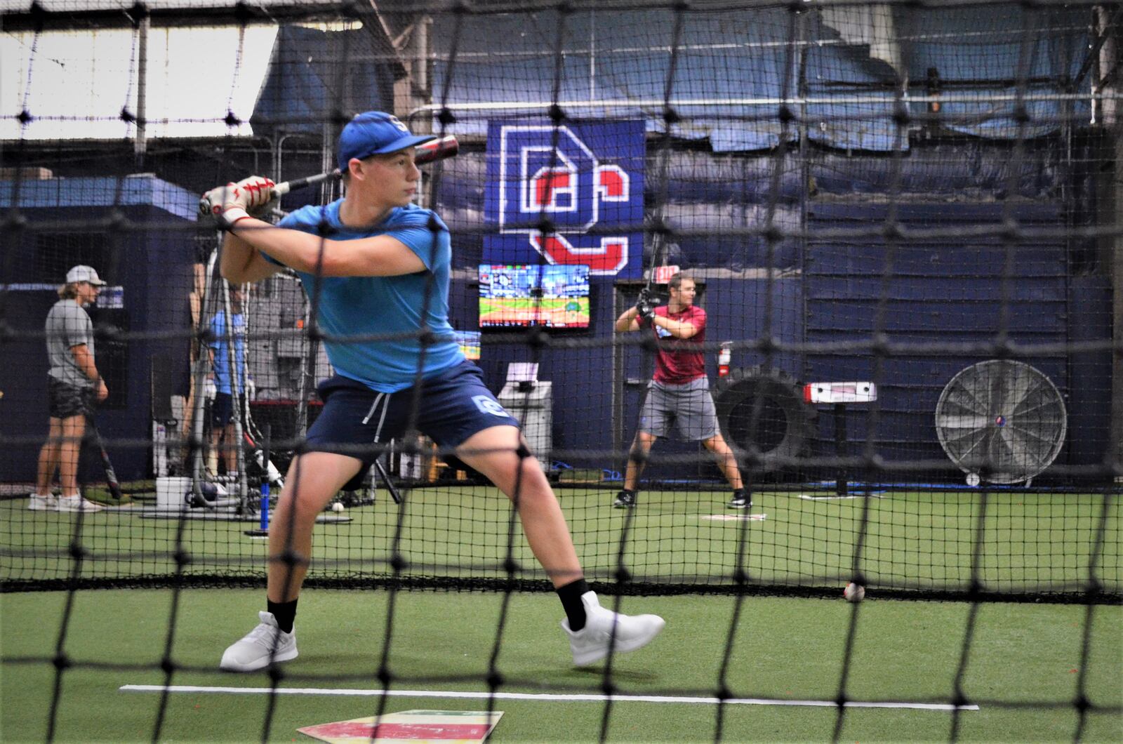 Liam Miller (front) and Matthew Roderer practice in the batting cages at Dayton Classics Baseball, August 20, 2023. LONDON BISHOP/STAFF