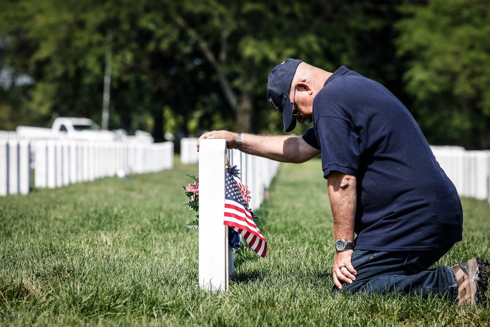 Fairborn resident and Retired Air Force master sergeant Henry Harlow delivers a flag to friend buried at the Dayton National Cemetery on West Third St. JIM NOELKER/STAFF