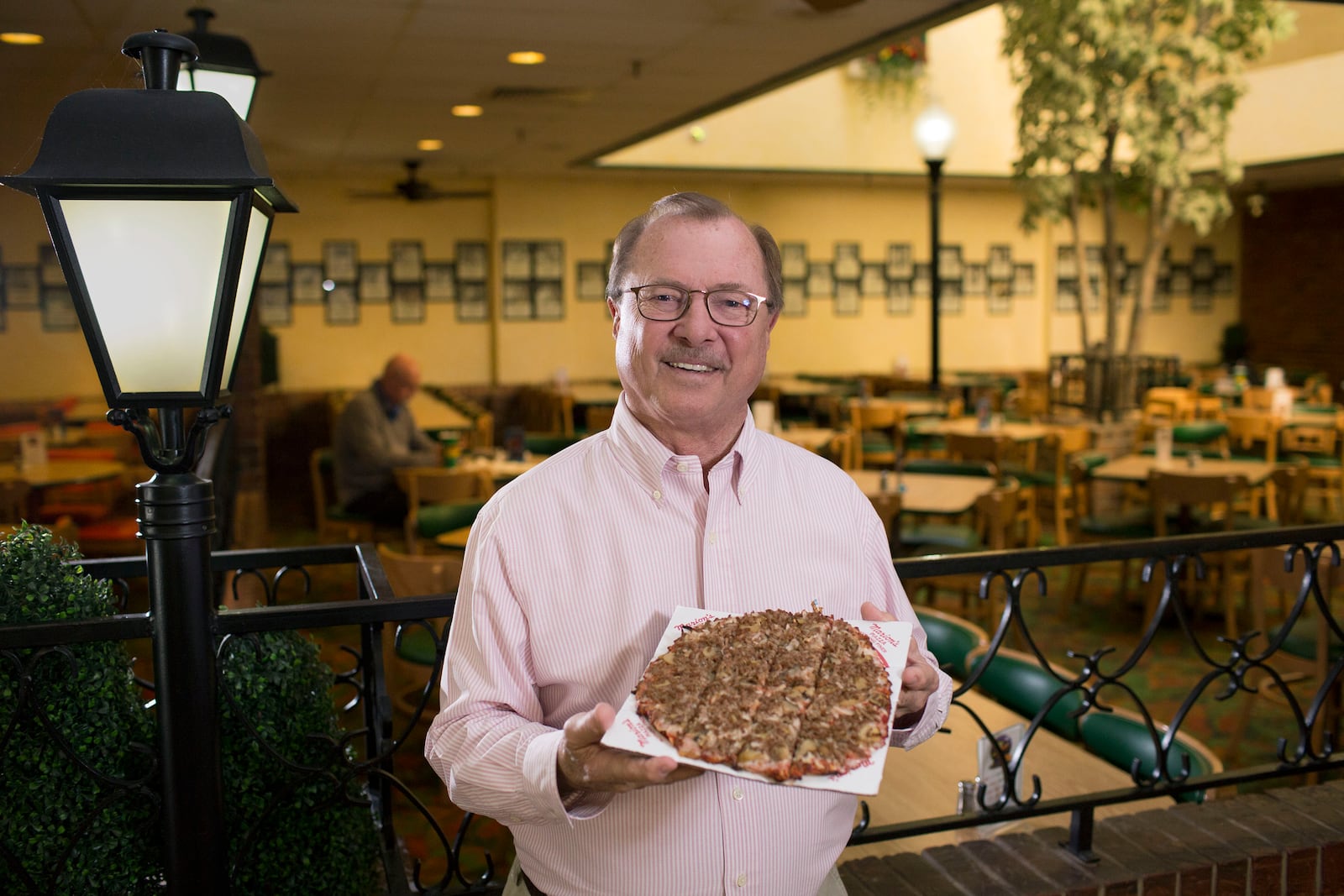 Roger Glass, owner, Marion's Piazza inside the Shroyer Rd. location.   Marion's and Cassano's are two local pizza giants who have held their ground in the ever-changing pizza landscape in Dayton.   TY GREENLEES / STAFF