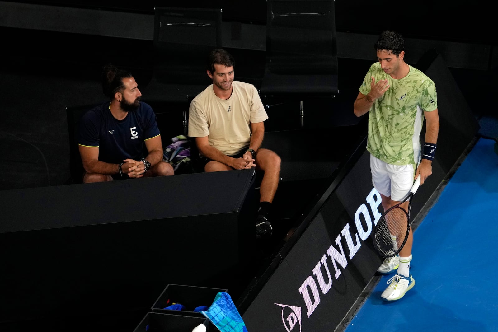 Matteo Gigante, right, of Italy stands by his coaches during his first round match against Ugo Humbert of France during their first round match at the Australian Open tennis championship in Melbourne, Australia, Sunday, Jan. 12, 2025. (AP Photo/Ng Han Guan)